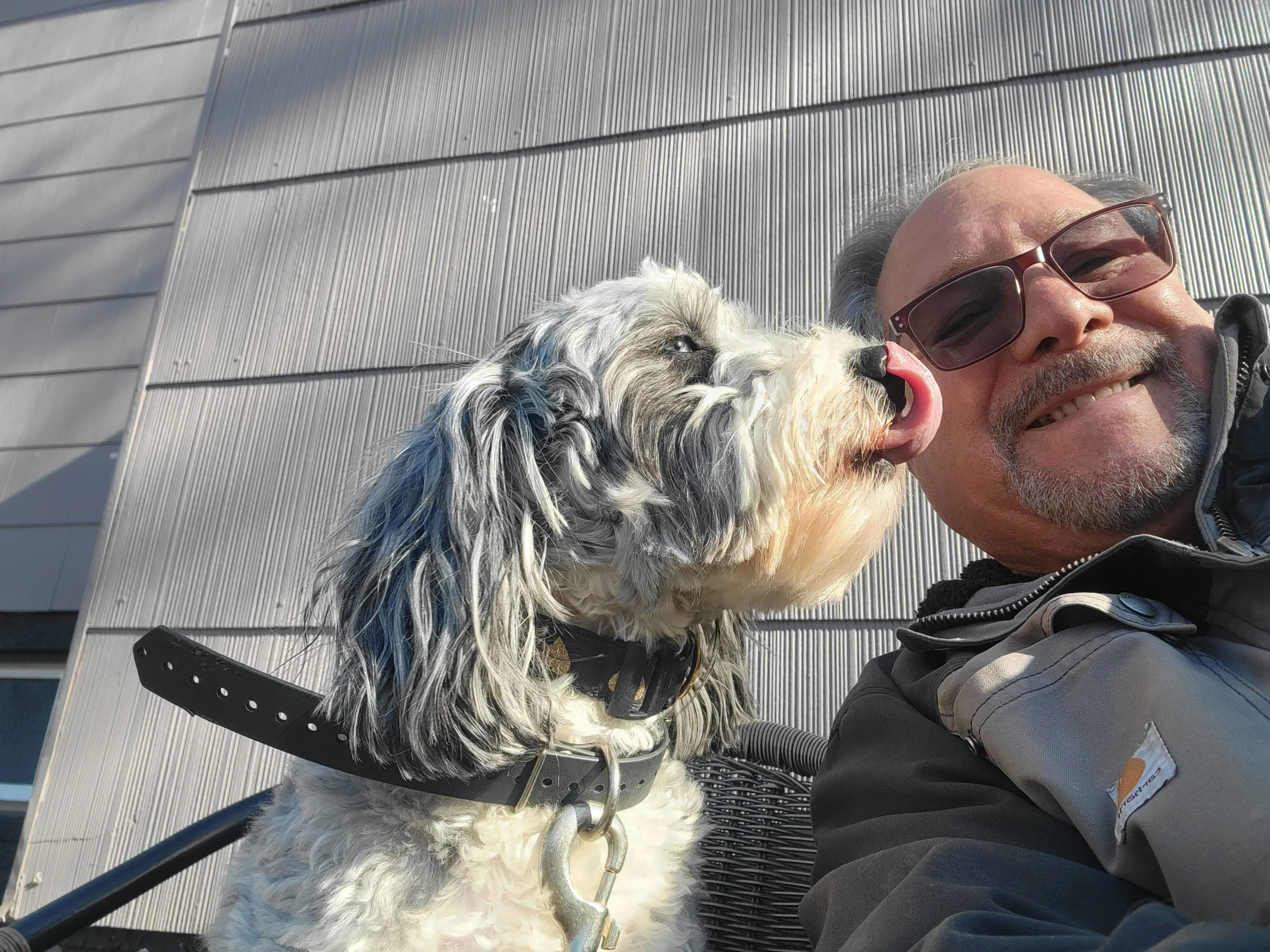 Robert smiling with a dog during a dog training session