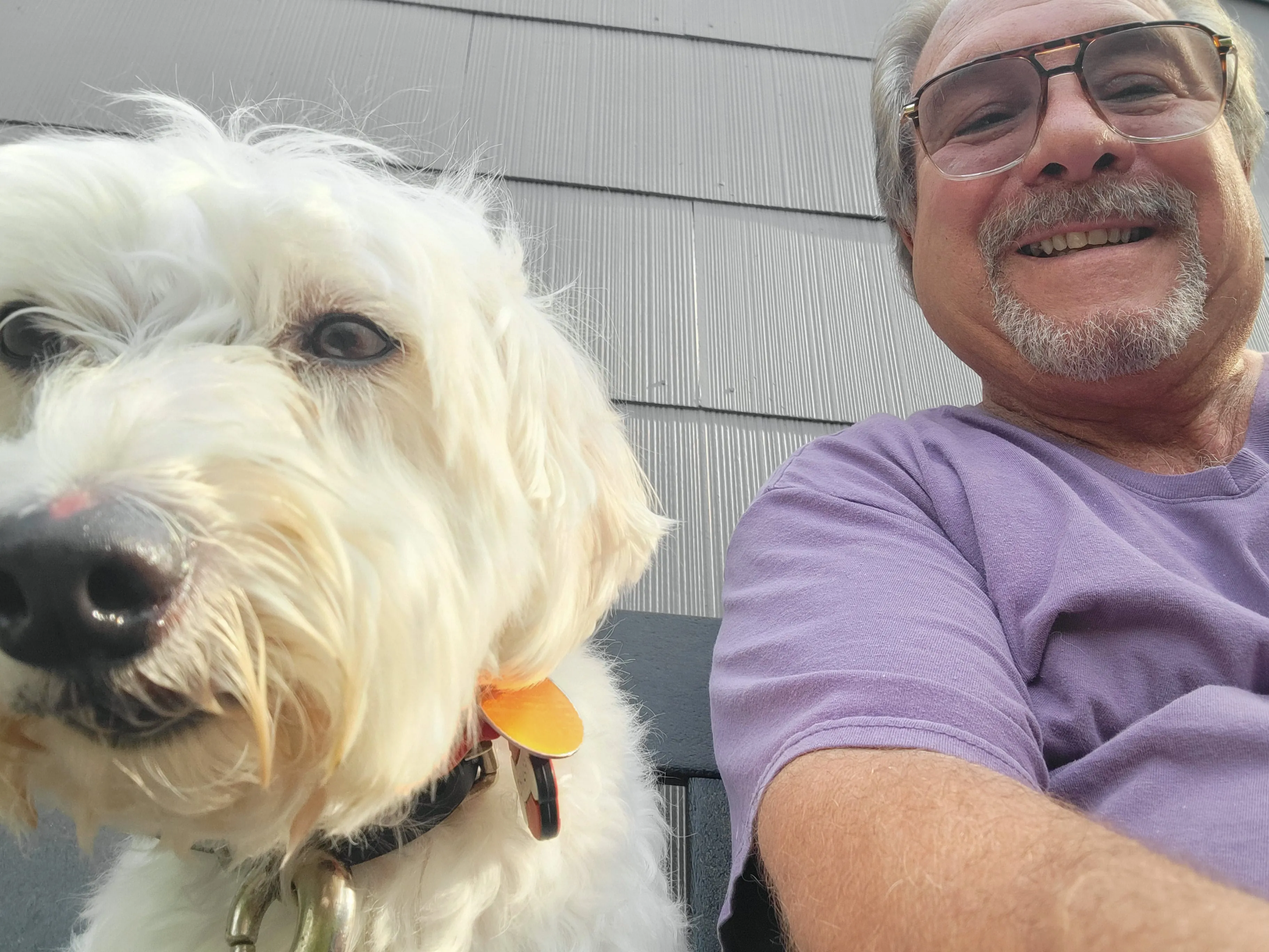 Robert posing with a white dog during dog training